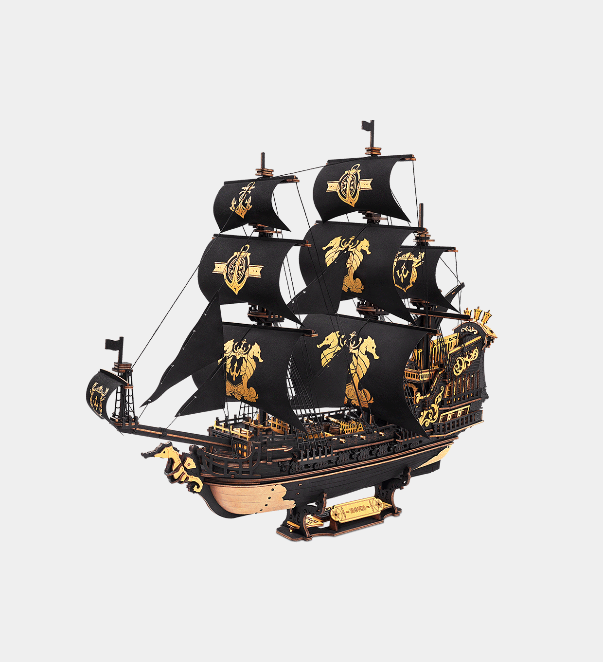Model of a black sailing ship with gold details on a light gray background