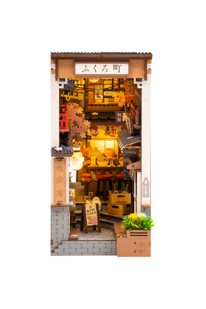 Miniature model of a store interior with various items and signs.