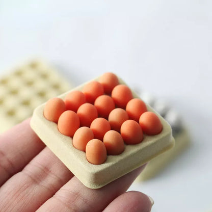 Small square toast with round orange bread pieces held by a hand on a light background